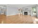 Open living room features hardwood floors, a fireplace, and a ceiling fan at 305 Mill Pond Se Ct, Smyrna, GA 30082
