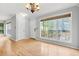 Bright living room featuring light hardwood floors, large window, and fresh paint at 305 Mill Pond Se Ct, Smyrna, GA 30082