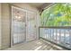 Patio with sliding glass doors, wood flooring, and painted wooden railing overlooking trees at 305 Mill Pond Se Ct, Smyrna, GA 30082