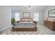 Stylishly staged bedroom with a wood-framed bed, plush bedding, and modern decor, enhanced by natural light at 5210 Davenport Pl, Roswell, GA 30075