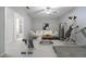 Open bonus room features a ceiling fan, exercise equipment, and an adjacent sitting area at 5210 Davenport Pl, Roswell, GA 30075