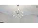 Modern starburst chandelier illuminating the room with its unique design and warm, inviting light at 5210 Davenport Pl, Roswell, GA 30075