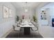 Dining room with contemporary chandelier, table set for dinner, and modern decor at 5210 Davenport Pl, Roswell, GA 30075