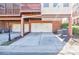 A townhouse showing the exterior view of a two-car garage with white doors and an adjacent brick facade at 5210 Davenport Pl, Roswell, GA 30075