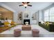 Bright and airy living room with built-in shelves, fireplace, and large windows at 5210 Davenport Pl, Roswell, GA 30075