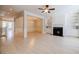 Open-concept living area featuring a fireplace, built-in shelving, and light wood flooring at 5210 Davenport Pl, Roswell, GA 30075