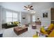 Comfortable living room featuring a ceiling fan, a fireplace, and ample natural light at 5210 Davenport Pl, Roswell, GA 30075
