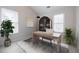 Office space featuring a modern desk, built-in bookshelf, and two windows for ample light at 5210 Davenport Pl, Roswell, GA 30075