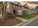 Street view of brick townhomes, manicured lawns, and curb appeal in a desirable neighborhood at 5210 Davenport Pl, Roswell, GA 30075