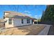 Backyard with a concrete patio space, grass lawn, and wooden fence creating a private outdoor oasis at 6515 Bentley Ridge Dr, Cumming, GA 30040