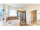 Bright bathroom features a soaking tub and glass-enclosed shower at 6515 Bentley Ridge Dr, Cumming, GA 30040