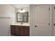 Bathroom featuring a single sink vanity with a large framed mirror and a view of the walk-in shower at 6515 Bentley Ridge Dr, Cumming, GA 30040