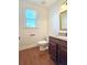 Well-lit bathroom features hardwood floors and a granite countertop at 6515 Bentley Ridge Dr, Cumming, GA 30040