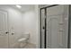 Bright bathroom with a white toilet and modern glass-door shower at 6515 Bentley Ridge Dr, Cumming, GA 30040