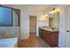 Bathroom featuring double vanity, granite countertop, and tiled shower at 6515 Bentley Ridge Dr, Cumming, GA 30040