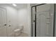 Bright bathroom featuring a standard toilet and a glass-enclosed shower with black trim at 6515 Bentley Ridge Dr, Cumming, GA 30040