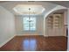 Bright dining room featuring hardwood floors, arched doorways, a trey ceiling, and large windows at 6515 Bentley Ridge Dr, Cumming, GA 30040