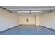Spacious two-car garage with epoxy flooring, white walls, and ample room for parking and storage at 6515 Bentley Ridge Dr, Cumming, GA 30040