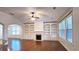 Open-concept living room with a fireplace, built-in shelving, hardwood floors, and ample natural light at 6515 Bentley Ridge Dr, Cumming, GA 30040