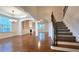 Spacious living room with hardwood floors, a fireplace, built-in shelving, and ample natural light at 6515 Bentley Ridge Dr, Cumming, GA 30040