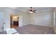 Spacious main bedroom featuring neutral colors, carpeted floor, and a ceiling fan at 6515 Bentley Ridge Dr, Cumming, GA 30040