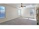 Spacious main bedroom with plush carpeting, ample natural light, and a ceiling fan for added comfort at 6515 Bentley Ridge Dr, Cumming, GA 30040