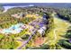 Aerial view showcasing the community pool, clubhouse, golf course, parking lot, and surrounding greenery at 200 Glen Wood Place, Canton, GA 30114