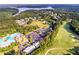 An aerial view of the community featuring a pool, golf course, parking, a lake and lots of trees at 200 Glen Wood Place, Canton, GA 30114