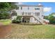 Expansive backyard with a deck, stairs, lush lawn, and shaded areas for outdoor enjoyment at 200 Glen Wood Place, Canton, GA 30114