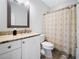 Bathroom with neutral paint, granite countertop and shower with patterned curtain at 200 Glen Wood Place, Canton, GA 30114