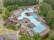 Aerial view of a large community pool complex with pools, water slides, lounge chairs, and umbrellas at 200 Glen Wood Place, Canton, GA 30114