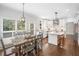 Dining area with windows, hardwood floors, and kitchen in background at 200 Glen Wood Place, Canton, GA 30114