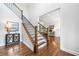 Spacious foyer with hardwood floors, staircase featuring iron railing, and a view into the office at 200 Glen Wood Place, Canton, GA 30114