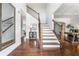 Elegant foyer boasts hardwood floors, a staircase with iron railing, and access to multiple rooms at 200 Glen Wood Place, Canton, GA 30114