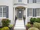 Inviting front door with a welcoming wreath, flanked by manicured landscaping and elegant railings at 200 Glen Wood Place, Canton, GA 30114