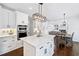 Bright kitchen features an island, stainless appliances, and white cabinets at 200 Glen Wood Place, Canton, GA 30114