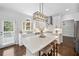 A bright kitchen features quartz counters, stainless appliances, and an island with seating at 200 Glen Wood Place, Canton, GA 30114