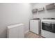 Laundry room features modern washer and dryer, storage and shelving at 200 Glen Wood Place, Canton, GA 30114