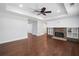 Spacious living room featuring dark hardwood floors and a cozy stone fireplace with built-in shelves at 200 Glen Wood Place, Canton, GA 30114
