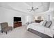 Comfortable main bedroom with neutral tones, a ceiling fan, and ample space for relaxation at 200 Glen Wood Place, Canton, GA 30114