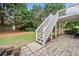 View of the backyard stairs leading to the deck area, and a cozy patio space at 200 Glen Wood Place, Canton, GA 30114
