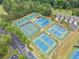 Aerial view of many tennis courts surrounded by lush trees, offering a vibrant outdoor recreational space at 200 Glen Wood Place, Canton, GA 30114