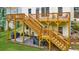 Multi-level deck and patio in backyard with stairs, stone pavers, and lush grass at 2653 W Main Nw St, Atlanta, GA 30318