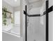 Bright bathroom featuring a tiled shower, garden tub, and greenery for a fresh look at 2653 W Main Nw St, Atlanta, GA 30318