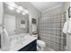 Cozy bathroom with a single sink, toilet, shower/tub combo with neutral shower curtain, and a mirrored medicine cabinet at 2653 W Main Nw St, Atlanta, GA 30318
