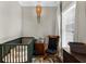 Charming Bedroom area with crib, rocking chair and vintage overhead lighting at 2653 W Main Nw St, Atlanta, GA 30318