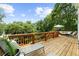 Expansive wooden deck with railings, offering outdoor seating and a lush green view at 2653 W Main Nw St, Atlanta, GA 30318