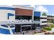 Daytime exterior shot of the Topgolf facility showing entryway, sign, and surrounding landscaping at 2653 W Main Nw St, Atlanta, GA 30318