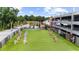 Outdoor area at Chattahoochee Works with artificial turf, picnic tables and string lights at 2653 W Main Nw St, Atlanta, GA 30318