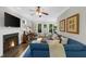 Comfortable living room with fireplace, flat screen tv, and plush sofa with neutral colored throw pillows at 2653 W Main Nw St, Atlanta, GA 30318